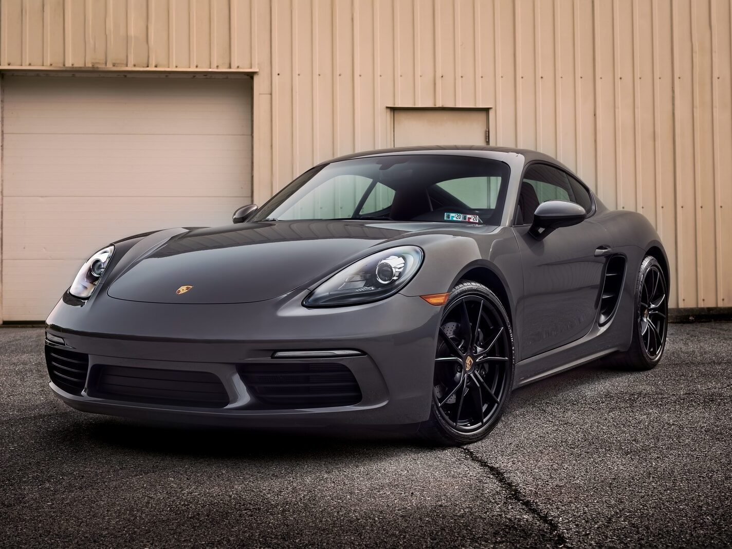 black porsche 911 parked near white wall