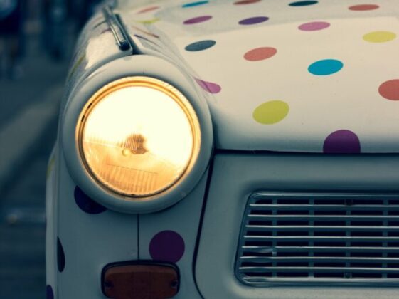 white and multicolored polka-dot vehicle with turned on headlight