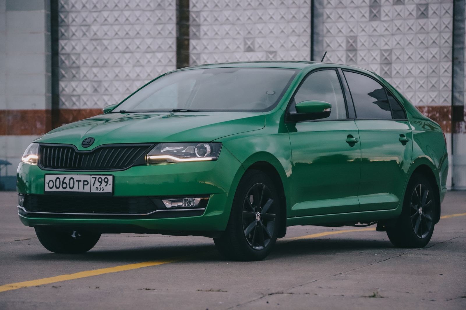 green volkswagen car parked on parking lot during daytime