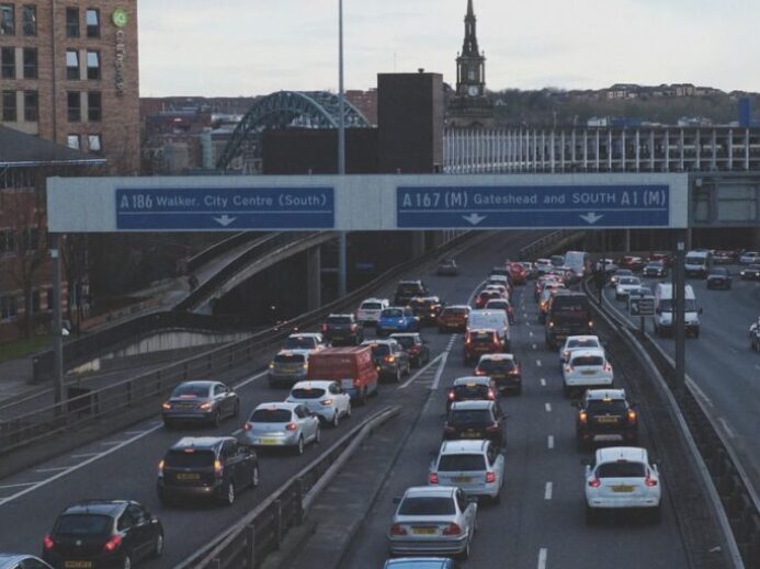 cars on road near bridge during daytime