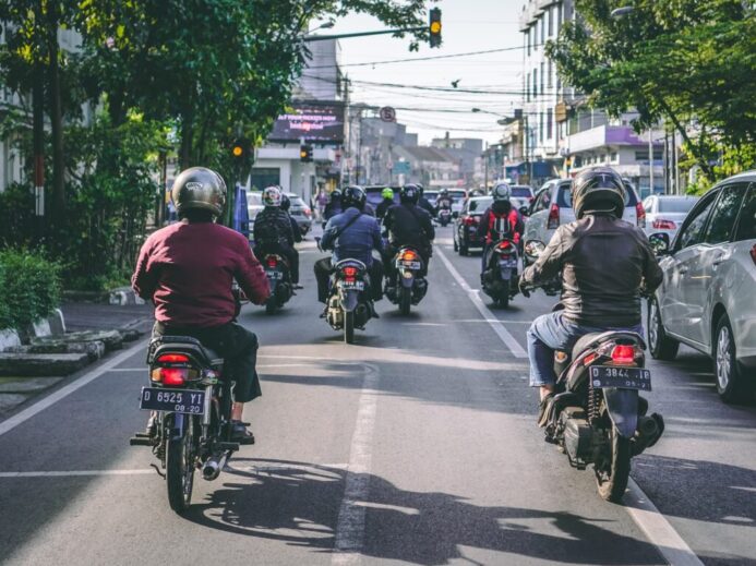 motorcycles and vehicles on road at daytime