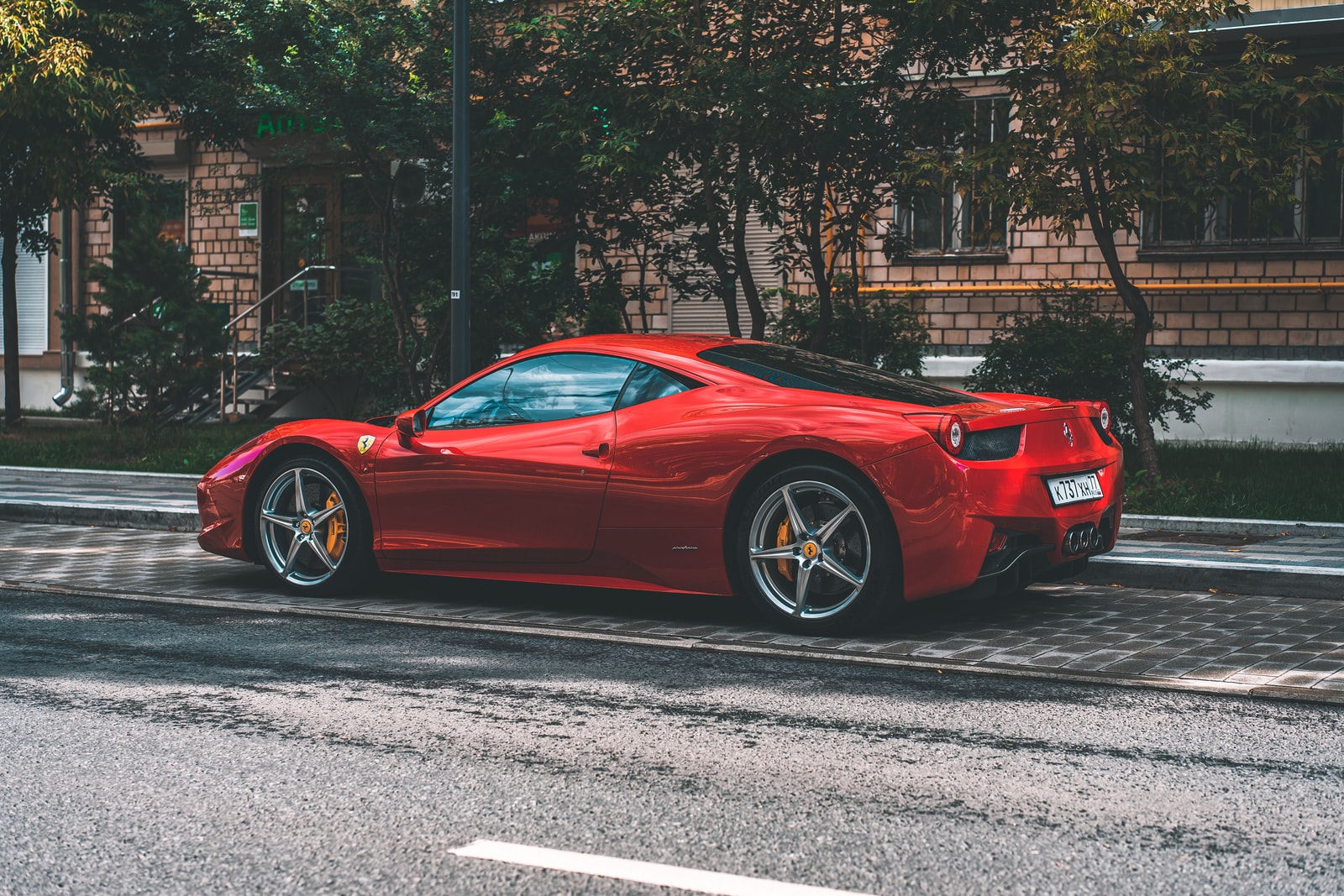 red ferrari 458 italia parked on road side during daytime