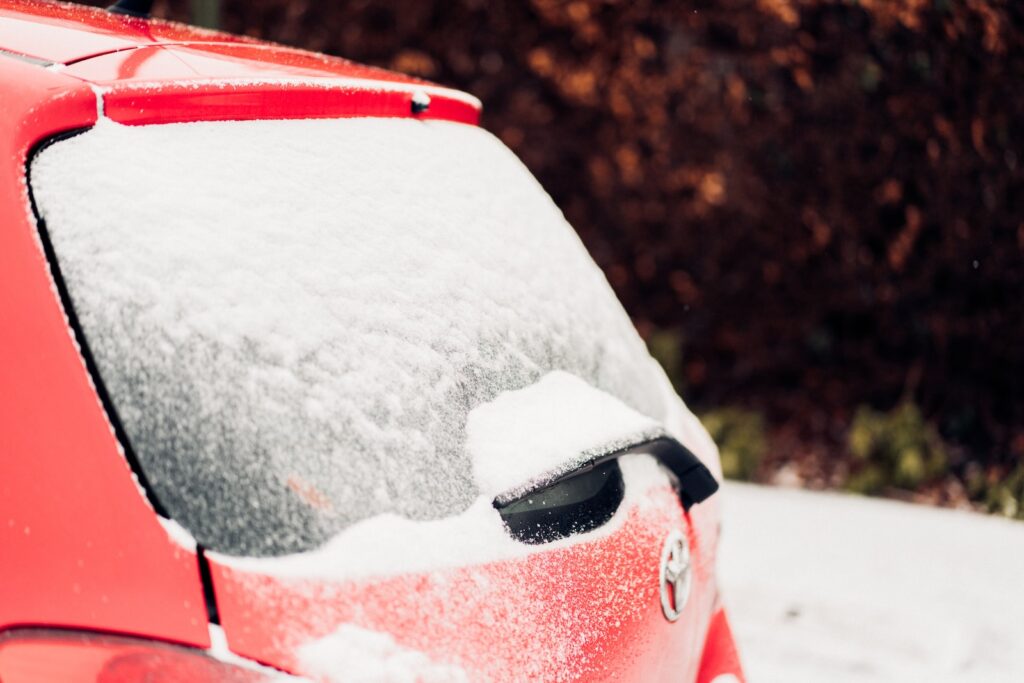 red and white car with snow on top