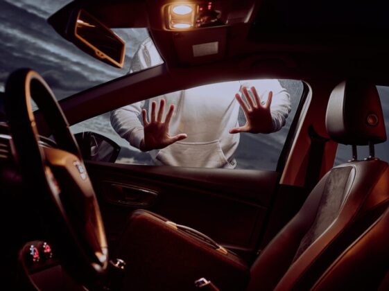 man in white long sleeve shirt driving car