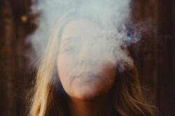 woman with white smoke on her face