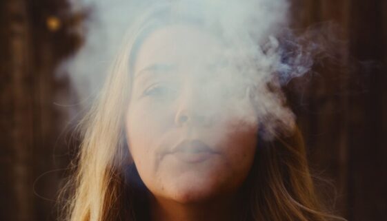 woman with white smoke on her face