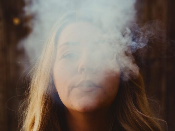 woman with white smoke on her face