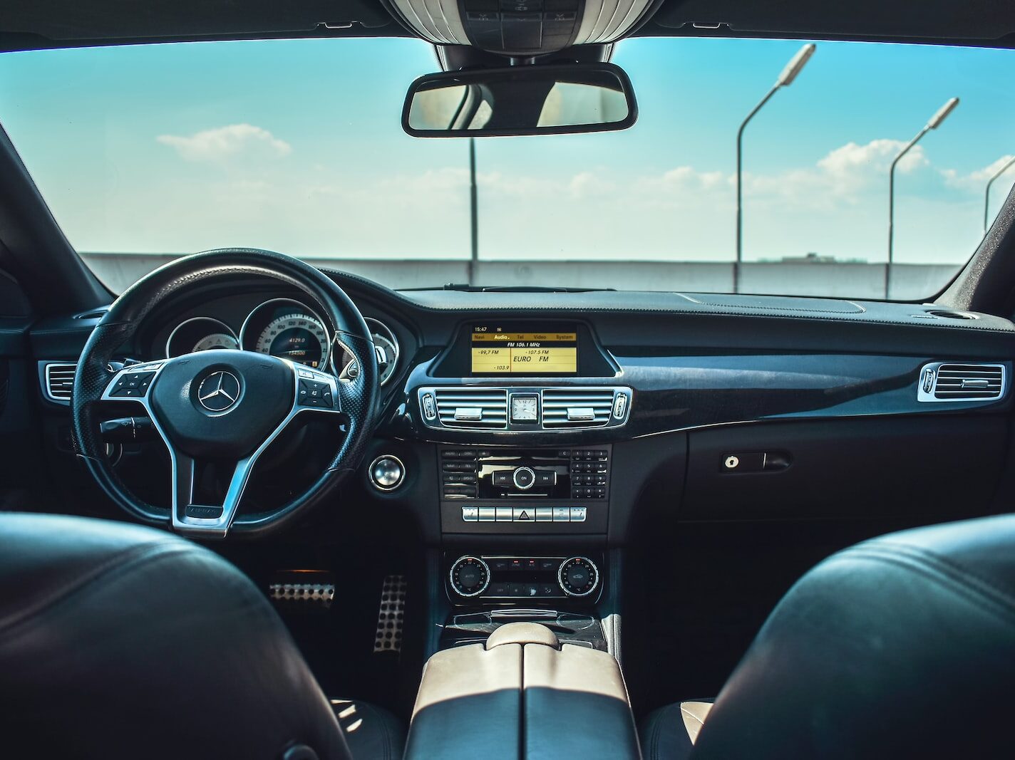 black Mercedes-Benz vehicle steering wheel