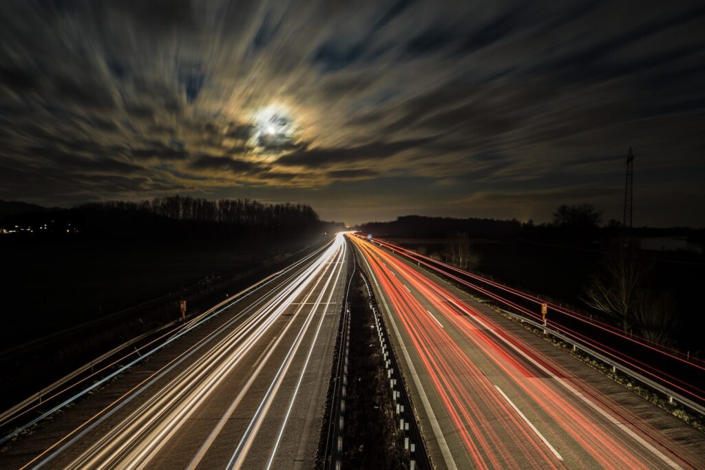 long exposure photography of vehicles at night time