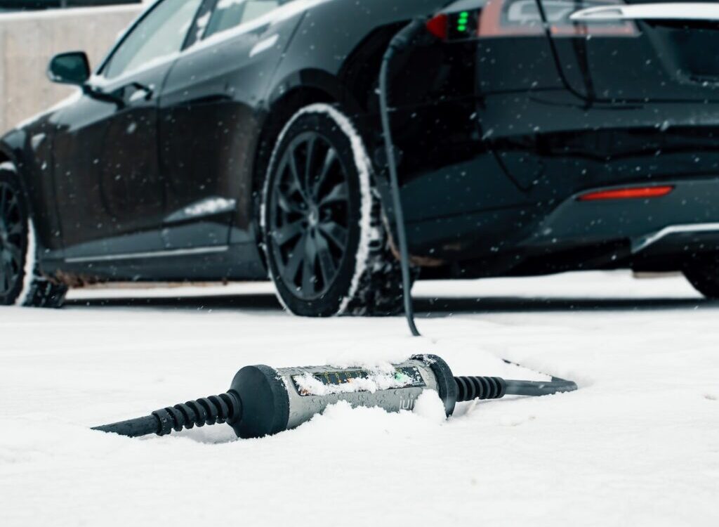 a car is parked in the snow next to a screwdriver