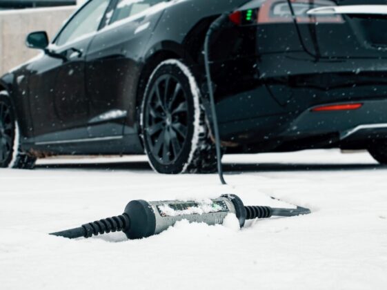 a car is parked in the snow next to a screwdriver