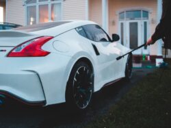 white porsche 911 parked near white house