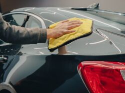 Hand Wiping a Car with a Cloth