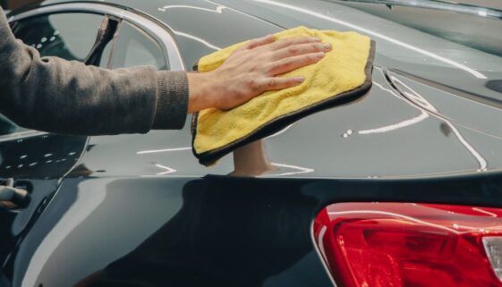 Hand Wiping a Car with a Cloth
