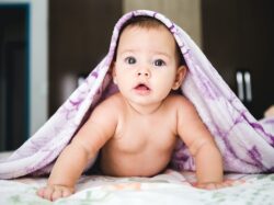 baby under purple blanket