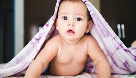 baby under purple blanket