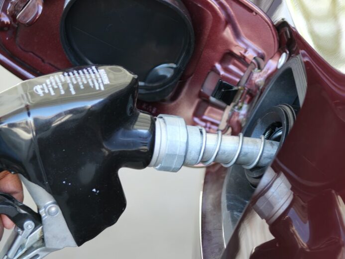 a close up of a person holding a gas pump