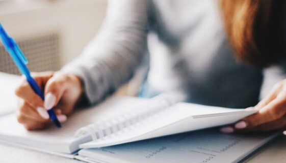 woman writing using pen