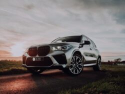 white bmw m 3 coupe on brown field under gray cloudy sky during daytime