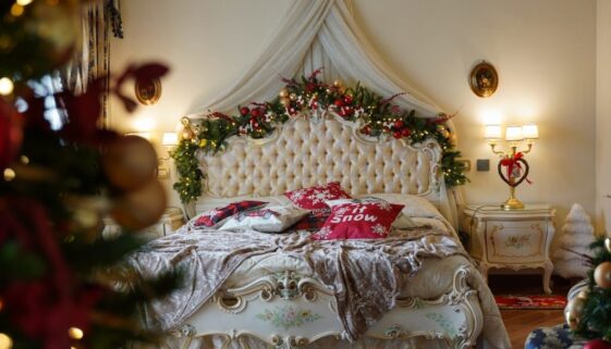 a bedroom decorated for christmas with a bed and a christmas tree