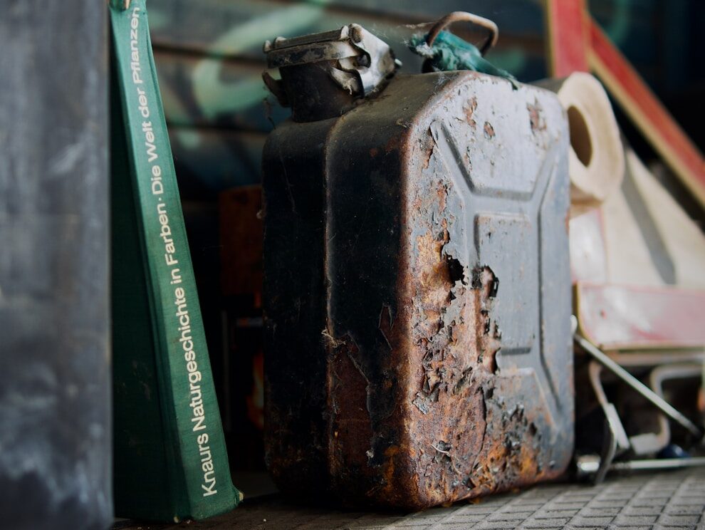 an old suitcase sitting on top of a table next to a book