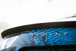 a close up of a blue and black car with the word alpine on it