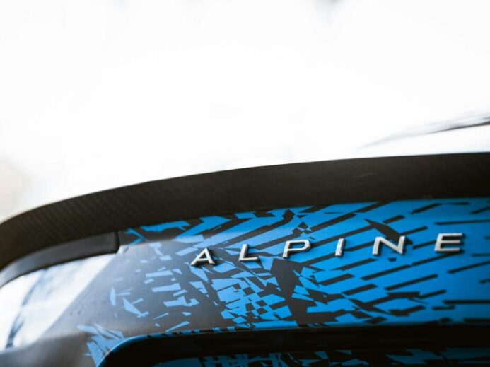 a close up of a blue and black car with the word alpine on it