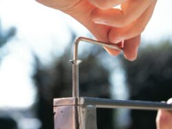 a close-up of a hand holding a metal rod