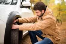 man check tyre outside