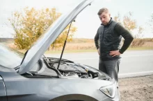Muž u otevřené kapoty