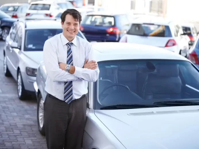 Muž u řady aut v autobazaru