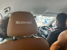 Pohled ze sedadla spolujezdce na řidiče BluSmart