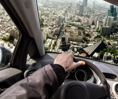 Auto letí nad městem, pohled z perspektivy řidiče
