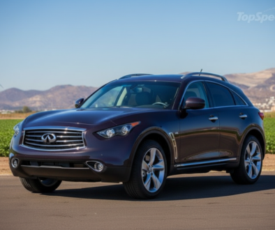 Maroon Infiniti SUV on a rural road with green fields, wind turbine, and distant mountains.